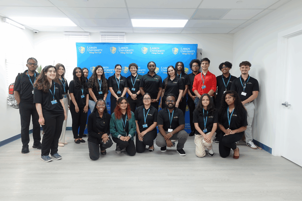 Group photo of Larkin University’s 2025 Summer Research Program (LUSRP) student cohort standing in front of a branded blue backdrop.