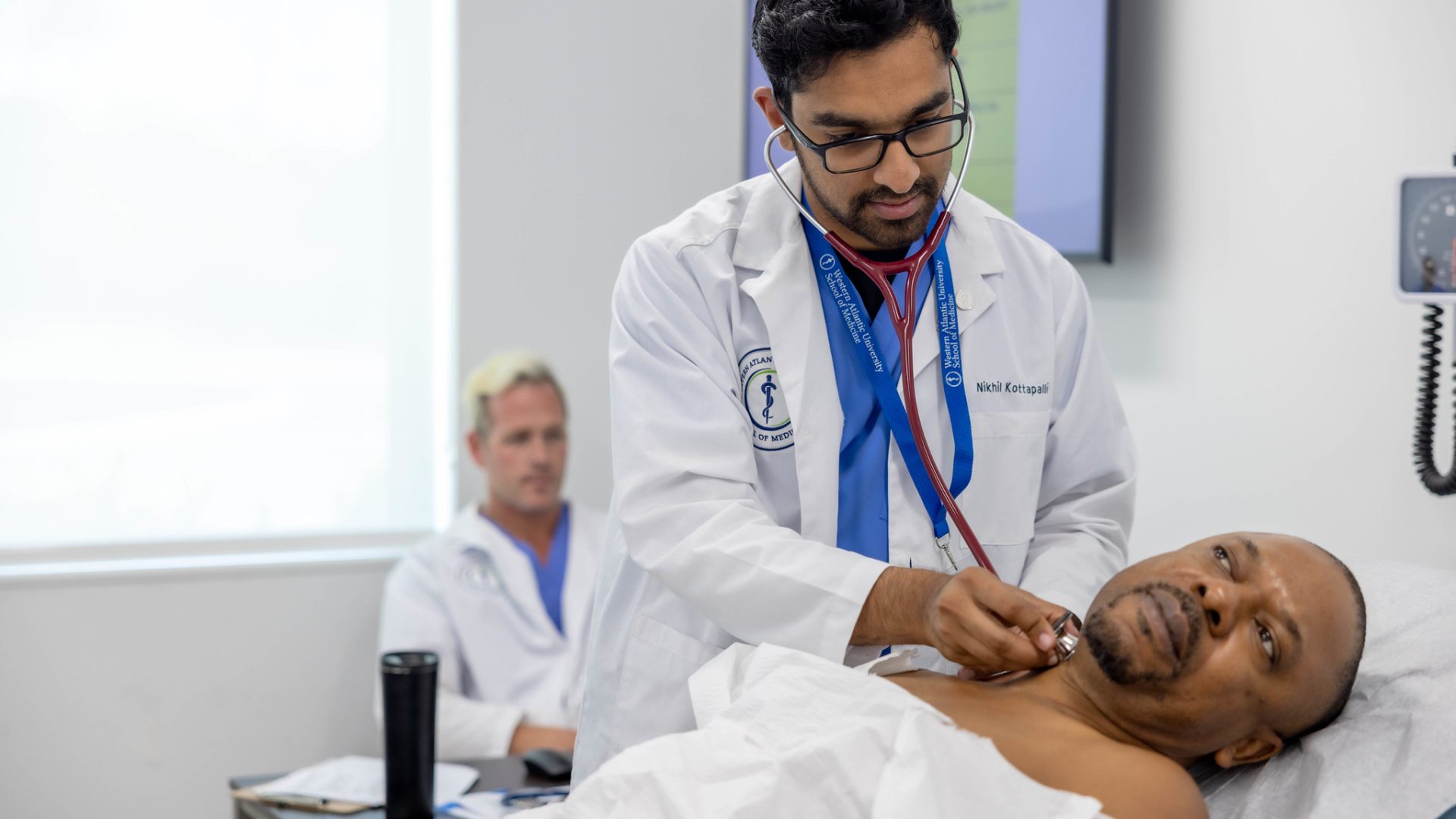 WAUSM medical student conducting a patient exam as part of the Larkin University to WAUSM Pathway program.